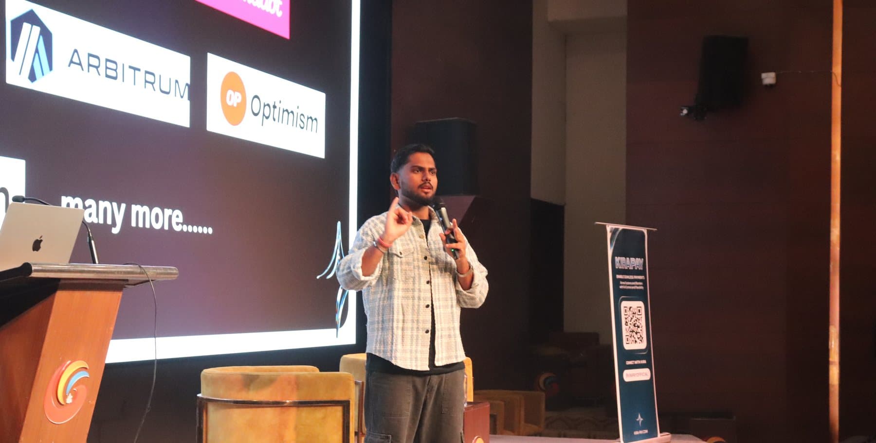 Nithin Mengani addressing a full auditorium